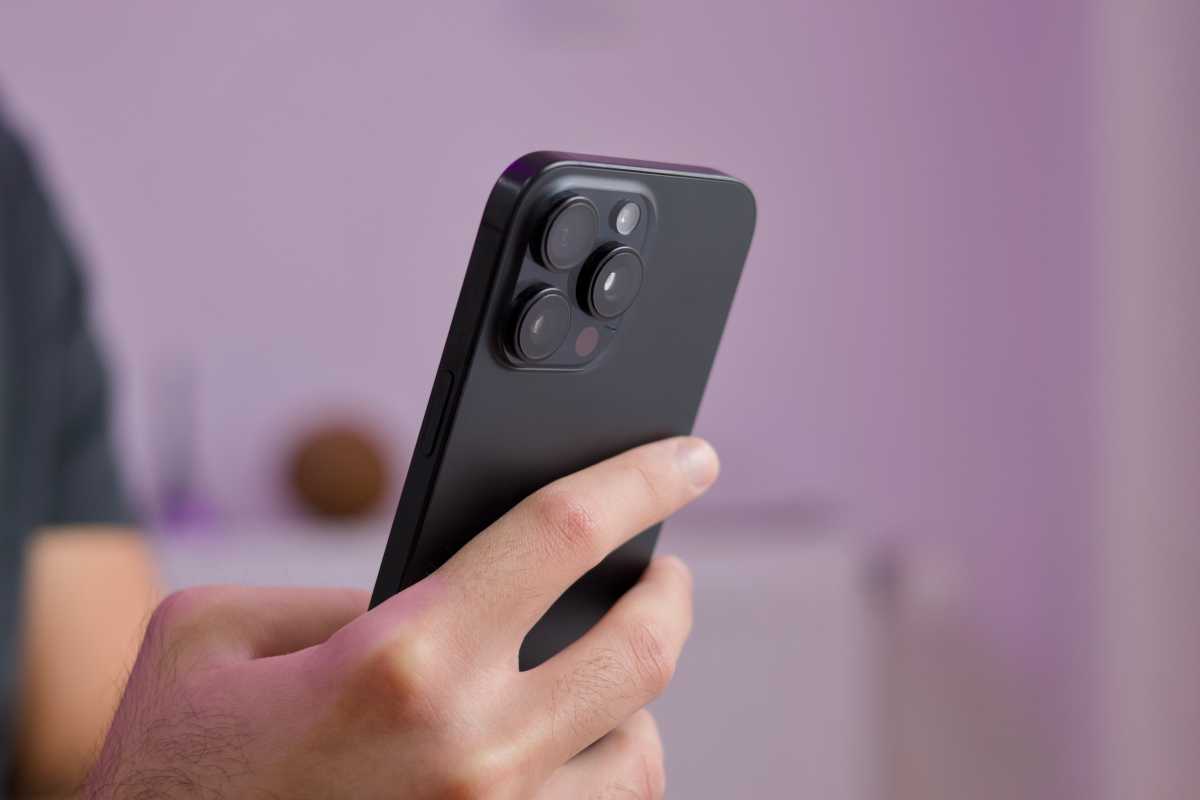 person holding an iphone 16 pro showing the back camera